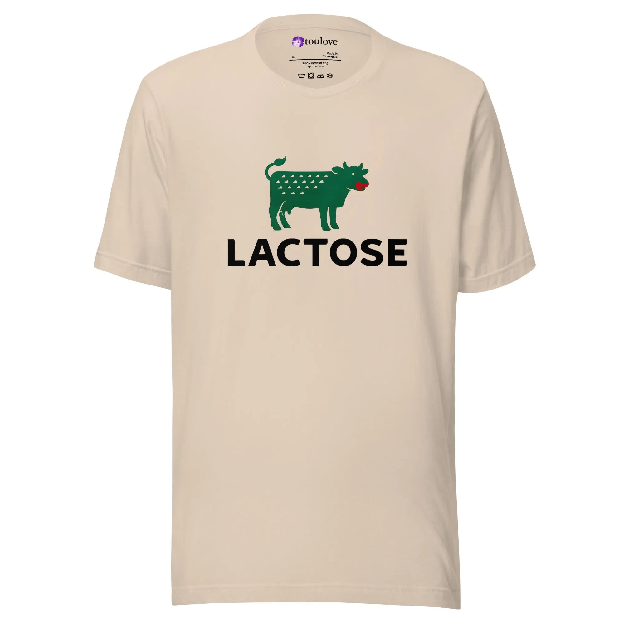 T-shirt imprimé Lactose beige avec vache verte et texte noir.
